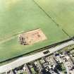 Oblique aerial view of Holywood centred on the excavation of a cursus and ring-ditch, taken from the E.