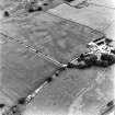 Bankhead, Dalswinton, oblique aerial view, taken from the WNW, centred on the cropmarks of Roman Forts and an oval enclosure.
