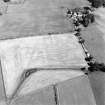 Oblique aerial view of Dalswinton, Bankhead, taken from the NW, centred on the cropmarks of Roman forts.  An enclosure, situated to the SE of the forts, is visible in the top right-hand side of the photograph.