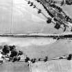 Oblique aerial view of Dalswinton, Bankhead, taken from the NE, centred on a linear cropmark.  An enclosure situated to the SW of the cropmark, is visible in the bottom left-hand corner of the photograph.