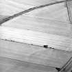 Oblique aerial view centred on the cropmarks of the Roman fort, pits and trackway, taken from the W.