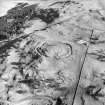Oblique aerial view centred on the remains of the fort, taken from the NW.