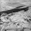 Oblique aerial view centred on the remains of the fort, taken from the W.