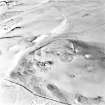 Oblique aerial view centred on the remains of the fort with the rig adjacent, taken from the NW.