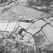 Oblique aerial view of Toft Knowes centred on the remains of a settlement surrounded by a field-system, rig and pens, taken from the NE.