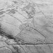 Oblique aerial view of Ettleton Sike centred on the remains of a farmstead, field-system, rig and boundary banks with further rig and boundary banks adjacent, taken from the NW.