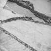 Oblique aerial view centred on the cropmarks of the settlements, taken from the E.