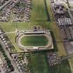 Oblique aerial view centred on the town's football ground, taken from the E.