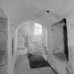 Interior view of Castle Fraser showing view of base of stair and porter's seat.