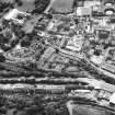 Aerial view of lower end of Canongate, also showing Holyrood Palace and Abbey to left of photograph, Holyrood Road, Meadow Flat Gas Holder Station at top, Regent Terrace at bottom and Calton Burial Ground in centre
