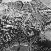 Oblique aerial view centred on the farmstead, the country house and hotel, taken from the W.