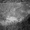 Tormore, oblique aerial view, taken from the W, centred on a hut-circle. A further hut-circle is visible in the centre right of the photograph.