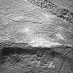 Torbeg, oblique aerial view, taken from the SW, centred on two hut-circles. A further hut-circle is visible in the bottom centre of the photograph.