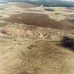 Tarbrax shale-oil works, oblique aerial view, taken from the SSW, showing the shale-oil mine's large spoil heap across the centre of the photograph, situated between a tramway, and the Tarbrax branch of the Caledonian Railway.