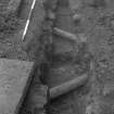 Falkland Palace Excavations
Frame 27 - Service pipes F408 and F412 cutting across channel - from west
