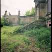 View from NW showing remains of front steps, quadrant screen wall and pavilion, Mavisbank House.