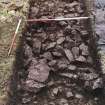 Cobbles, rubble and wall in Trench 5, from the E.