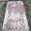 Forgan, St. Fillan's Churchyard.
General view of a recumbant gravestone with decorative border and winged soul, cartouche, hourglass, skull and crossed bones.