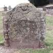 Forgan, St. Fillan's Churchyard.
General view of gravestone. Stone with curved top. Inscription panel flanked by double torches of Life and Death, and 'suspended' from rosettes. Winged soul with anchor, sextant and star.