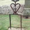 Forgan, St. Fillans Churchyard.
General view of Iron memorial. An iron frame which once held an inscribed tablet (missing), with heart enclosing a cross above. The memorial is topped by a masonic symbol of dividers and set-square.