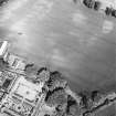 Pitmuies, oblique aerial view, taken from the SW, centred on the cropmarks of a pit-circle and a possible unenclosed settlement, linear cropmarks and rig. Pitmuies garden is visible in the bottom left-hand corner of the photograph.