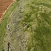 Oblique aerial view of Traprain Law fort centred on summit excavations undertaken in July 1997, taken from the NE.