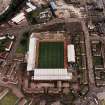 Oblique aerial view centred on the football stadium, taken from the W.