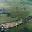 Oblique aerial photograph of Forth-Clyde Junction Railway Pipe Bridge (top), Balfron Station A81 Pipe Bridge, and Ebbdon Pipe Depot, with Balfron Station Syphon under A811 and the Ballat Water Chambers and valve house compound beyond
