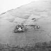 Oblique aerial view centred on the pound and farmstead with the site of the chapel adjacent, taken from the E