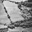 Oblique aerial view centred on the cropmarks of the possible unenclosed settlement, rig, and linear cropmarks with the country house, farmsteading, garden, walled garden and gate piers adjacent, taken from the N.