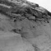Photograph showing erosion of structural features in cliff.