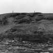 Photograph showing coastal erosion of structural features.