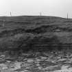 Photograph showing coastal erosion of structural features.