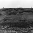 Photograph showing coastal erosion of structural features.