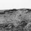 Photograph showing coastal erosion of structural features.