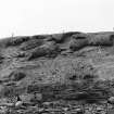 Photograph showing coastal erosion of structural features.