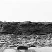 Photograph showing coastal erosion of structural features.