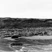 Photograph showing coastal erosion of structural features.