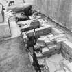 Excavation trench along side of church.