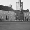 View of 71-75 George Street, Whithorn, with Old Town Hall steeple in the background, from south east.