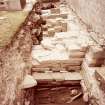 Excavation trench along base of church wall. Skeleton in situ.