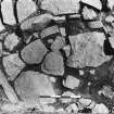 Excavation photograph : trench AH Baulk - detail showing flagged floor L337 with wall L336 behind.

