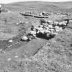 Excavation photograph : Hut Circle I - section across wall - soil stripped.