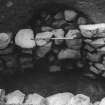 Excavation photograph : alcove in SW wall of souterrain with blocking.