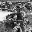 Excavation photograph : view from east of entrance, cell, furnace and wheelhouse.