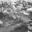 Excavation photograph : oval setting of slabs in central area of larger wheelhouse.