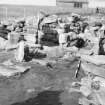 Excavation photograph : oval setting of slabs in larger wheelhouse.