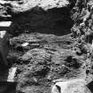 Excavation photograph showing timber floor outside Guardhouse, view taken from outer post hole at entrance
Duplicate photographic print available in MS/1179/1
