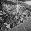 Excavation photograph of area OP8 showing tilted stones on top of wall
Duplicate photographic print available in MS/1179/1