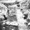 Excavation photograph showing entrance way, crossways timbers cut away during 1973 excavations
